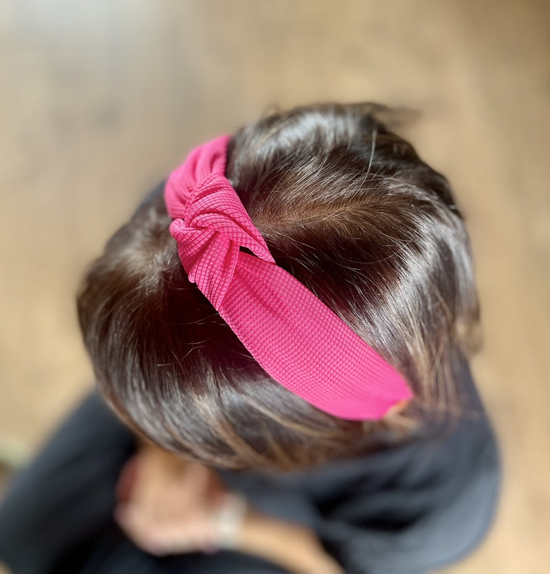 Bright Knot Alice Band in Pink on head