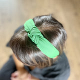 Bright Knot Alice Band in green on head